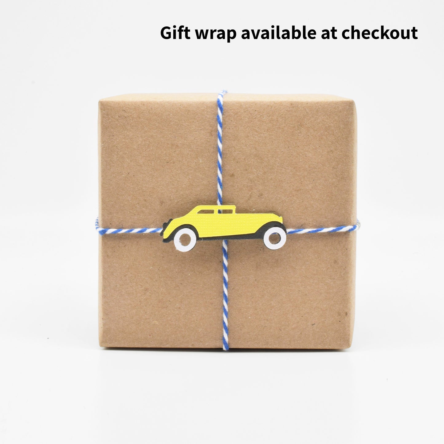 The gift wrap features a paper cutout of Jay Gatsby's yellow sports car.