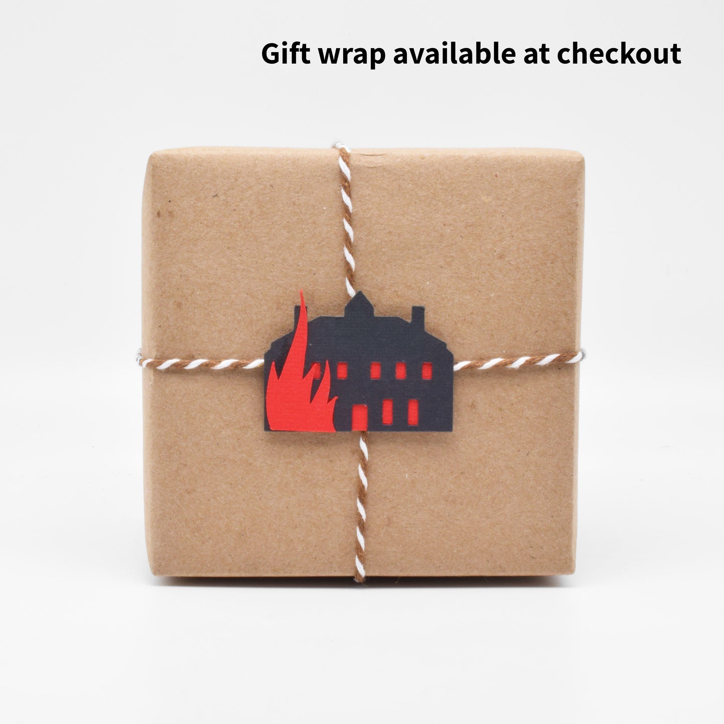 The gift wrap features a tiny paper cutout of Thornfield Manor going up in flames.