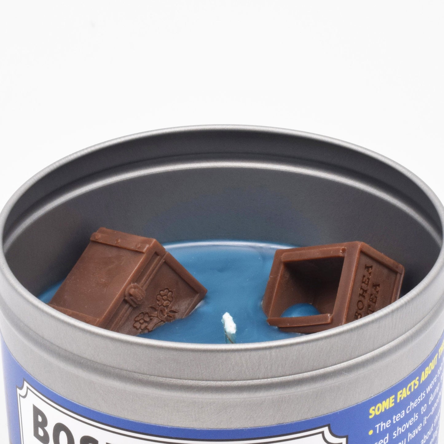 The surface of the candle has miniature wax tea chests that are modeled after the actual tea chests thrown into Boston Harbor during the Boston Tea Party.
