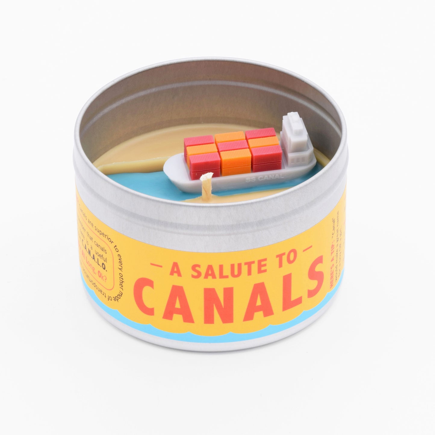The Salute to Canals candle has a miniature scene on its surface with a tiny container ship floating down a canal.