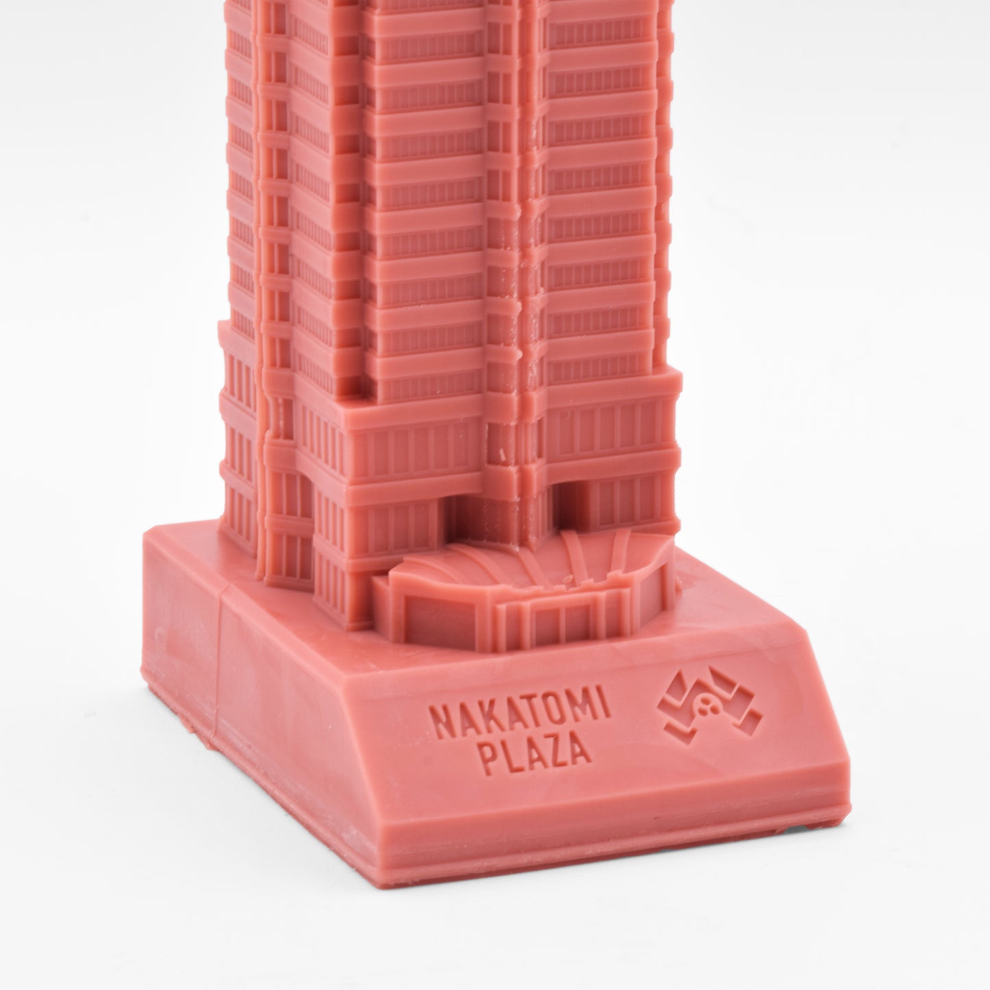 The base of the candle is engraved with the corporate logo of the Nakatomi corporation.