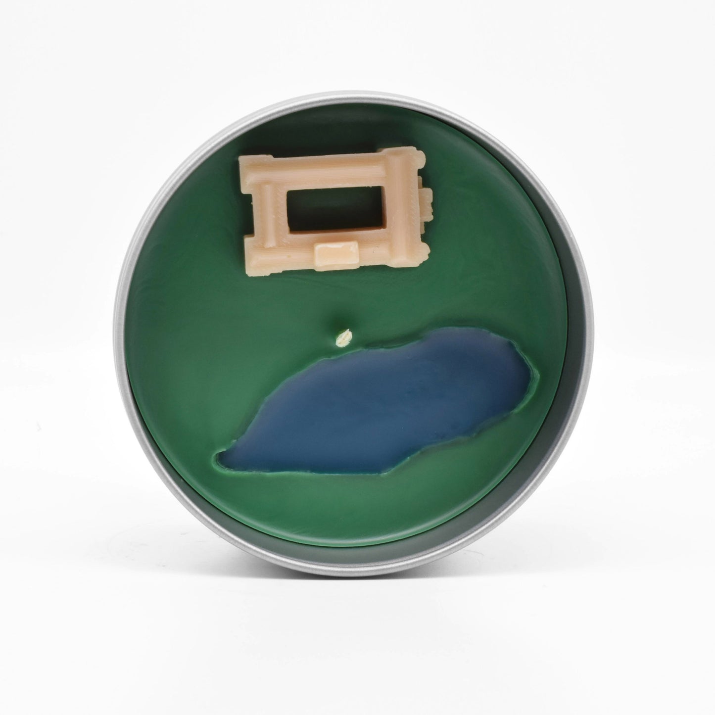The surface of the candle features a miniature wax replica of Pemberley from the BBC adaptation of Pride and Prejudice.