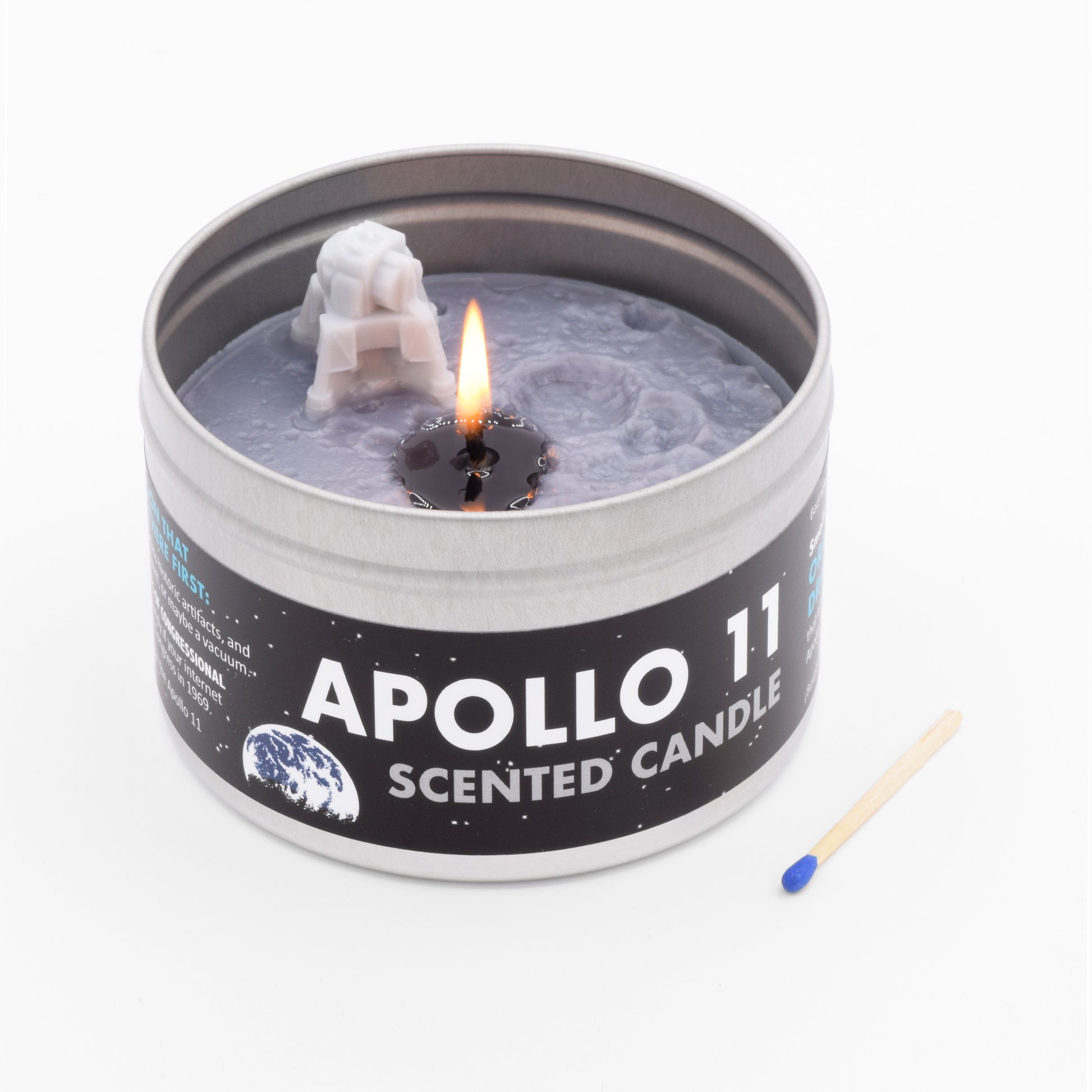 The Apollo 11 Scented Candle smells like Tang and has a miniature lunar module on its surface.