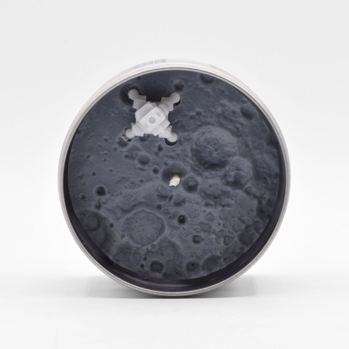 The Apollo 11 Scented Candle is modeled to look like the moon surface and features a miniature lunar module.