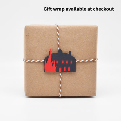 The gift wrap features a tiny paper cutout of Thornfield Manor going up in flames. 