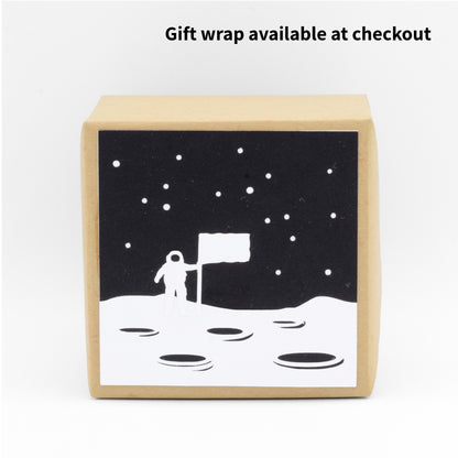 The gift wrap depicts a scene of the moon landing.