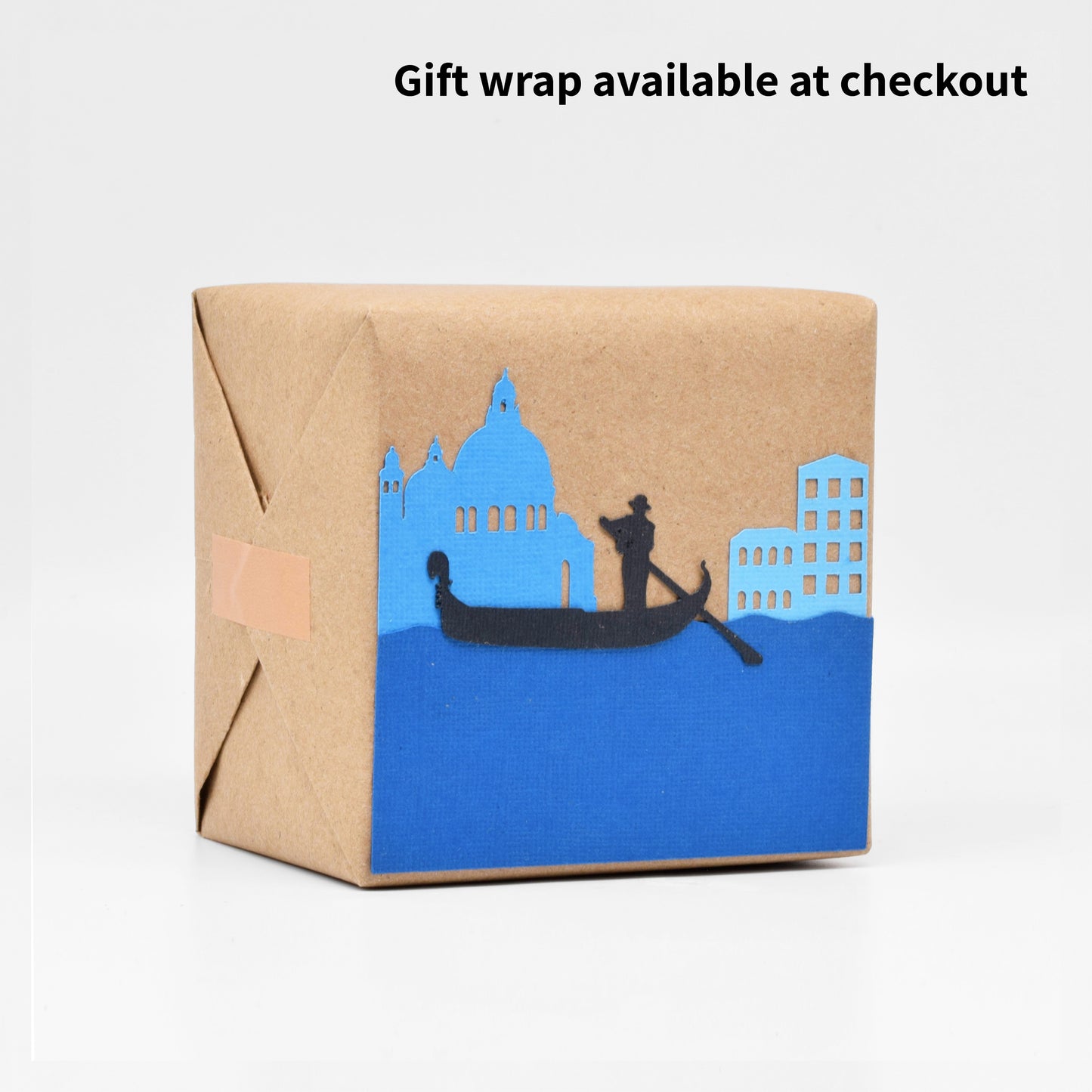 The gift wrap has paper cutouts depicting a Venetian canal and canal boat. 