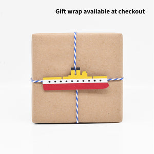 The gift wrap features a paper cutout of the warship the USS Maine. 