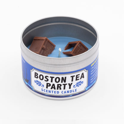 Boston Tea Party Scented Candle with iced tea fragrance, featuring wax embeds of tea chest, symbolizing the historic protest against British taxes.