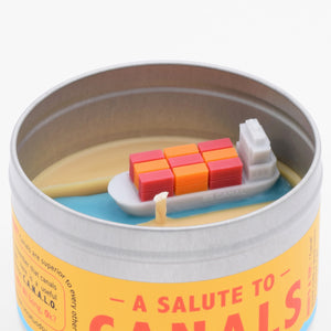 The Salute to Canals candle has a miniature container ship on its surface, making it a funny and unique gift for someone who remembers the Ever Given ship was stuck in the Suez canal.