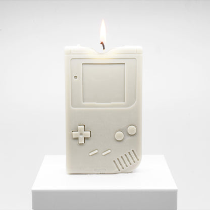 Candle replica of a handheld video game player