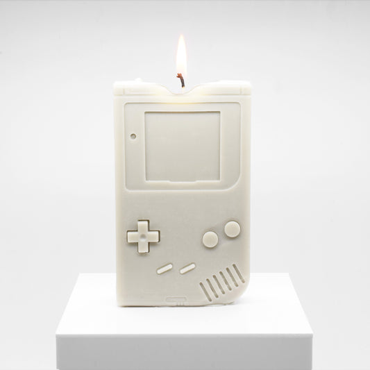 Candle replica of a handheld video game player