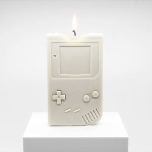Candle replica of a handheld video game player