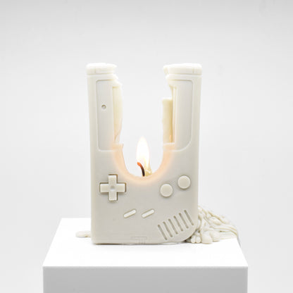 Candle replica of a handheld video game player