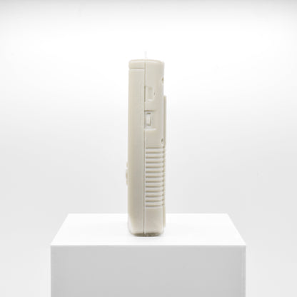 Candle replica of a handheld video game player