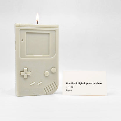 Candle replica of a handheld video game player